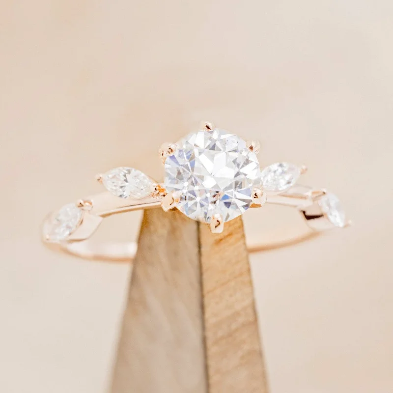 "FLORA" - ROUND CUT MOISSANITE ENGAGEMENT RING WITH LEAFCUT DIAMOND ACCENTS